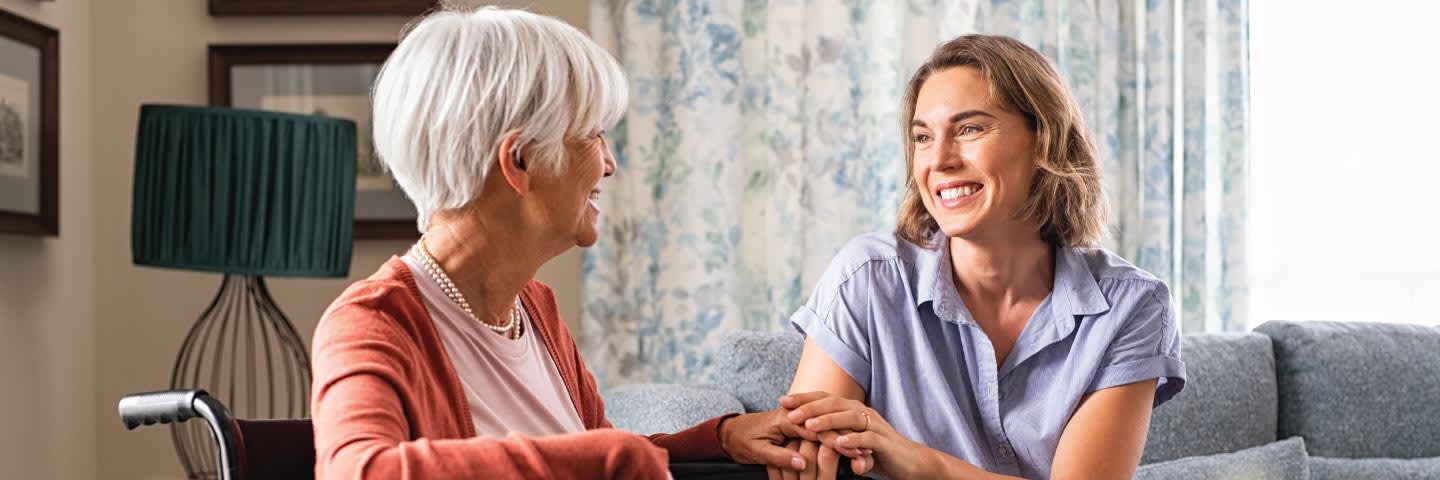 Elderly woman and younger woman talking